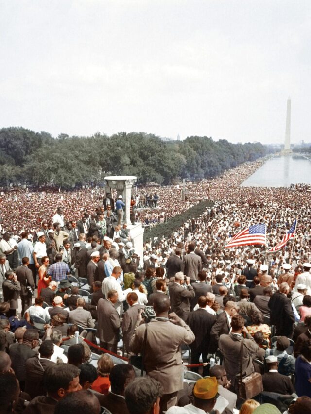 Black-and-white 1960s NC civil rights protest with marchers.